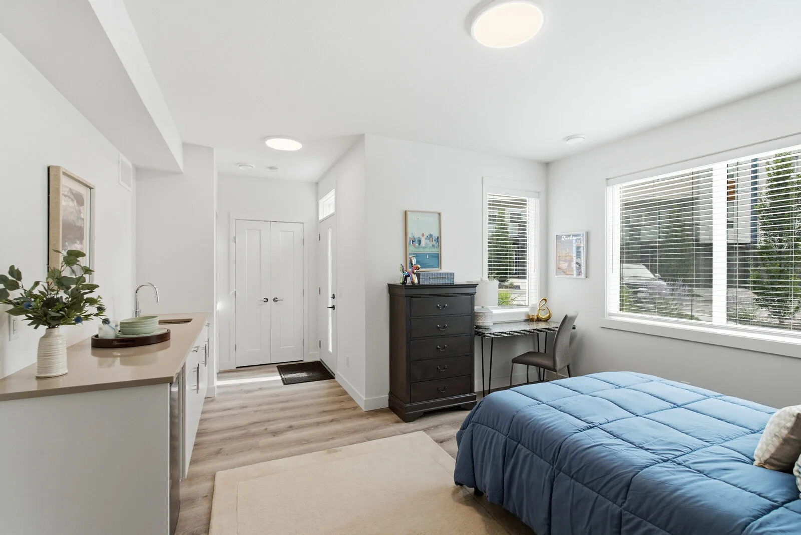 A lock-off flex room set up as a bedroom, with its own wet bar and separate entrance at Academy Ridge